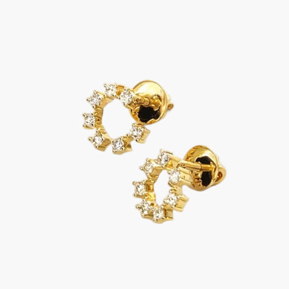 Gold hoop earrings with clear stones on a white background