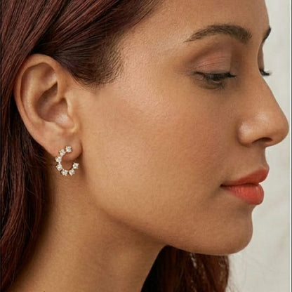 Close-up of a woman wearing earrings with a neutral background