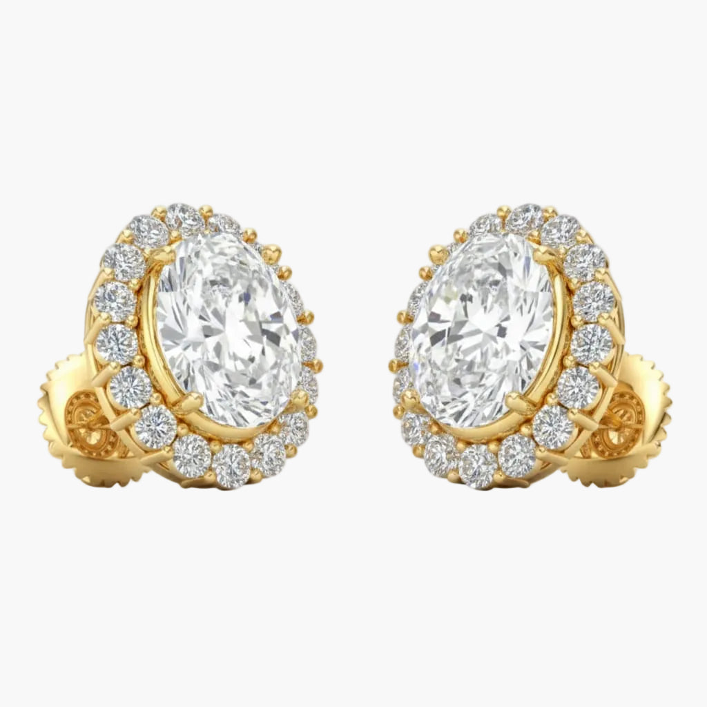 Gold earrings with large central gemstones and smaller stones around on a light gray background