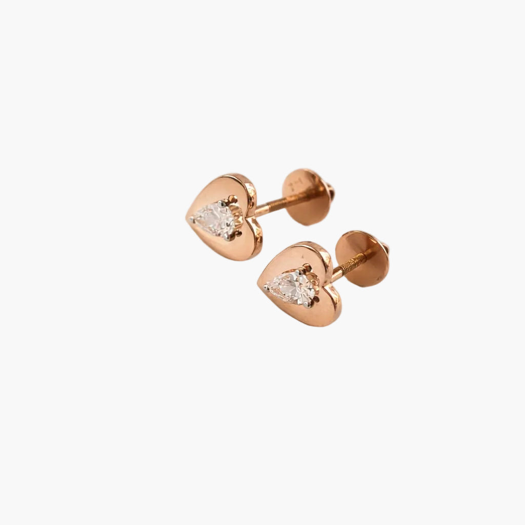 Rose gold heart-shaped earrings with clear gemstones on a white background