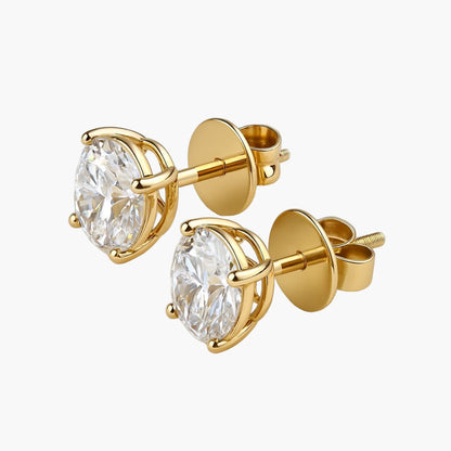 Gold stud earrings with clear gemstones on a white background