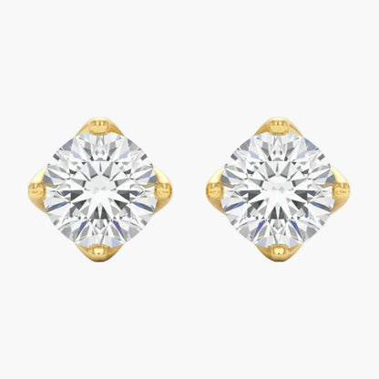 Gold earrings with clear gemstones on a white background