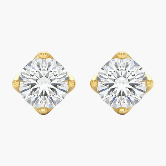 Gold earrings with clear gemstones on a white background