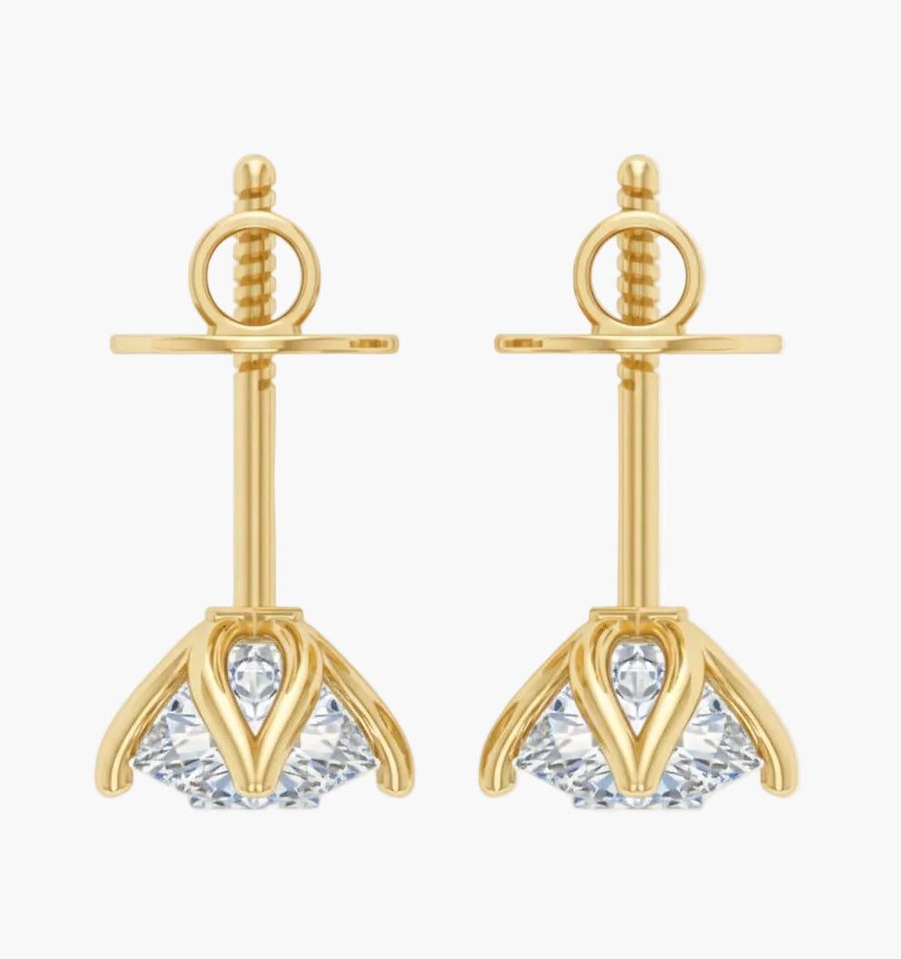 Gold earrings with clear gemstones on a white background