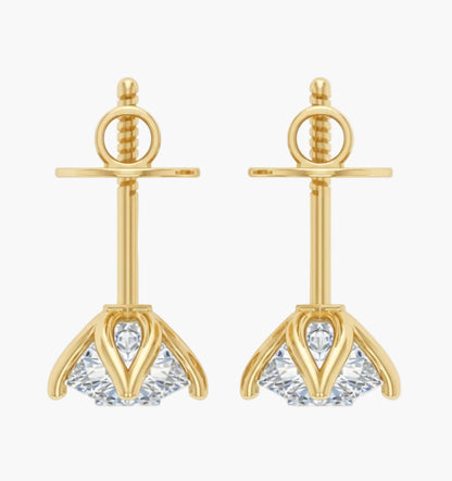 Gold earrings with clear gemstones on a white background