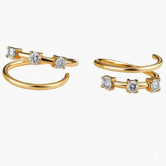 Gold open hoop earrings with embedded diamonds on a white background