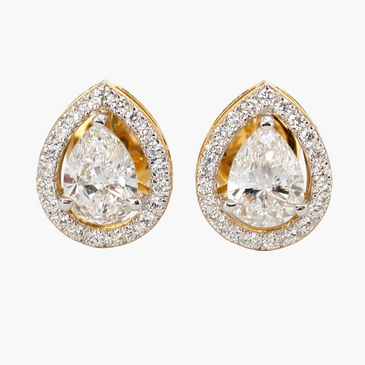 Pair of gold and diamond teardrop earrings on a white background