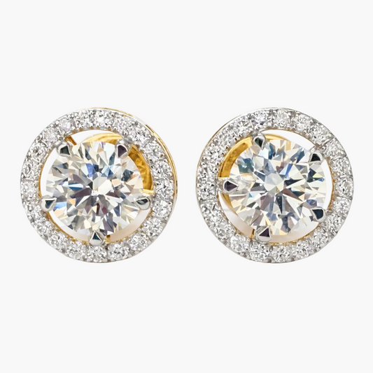 Pair of gold and silver round earrings with clear gemstones on a white background