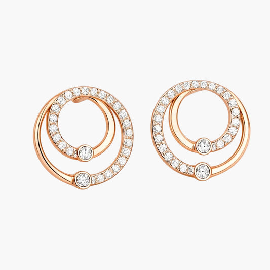 Rose gold earrings with circular design and embedded diamonds on a white background