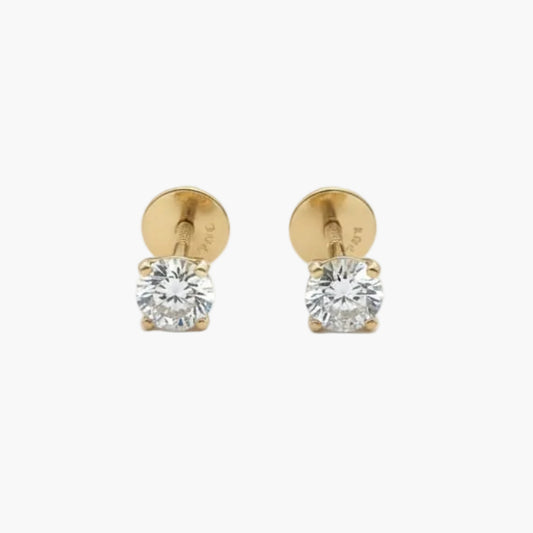 Gold stud earrings with clear gemstones on a white background