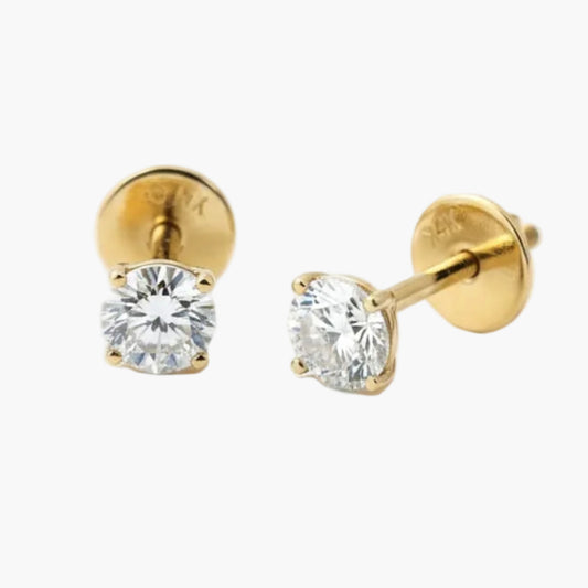 Gold stud earrings with clear gemstones on a white background