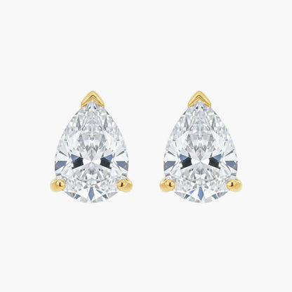 Pair of pear-shaped diamond stud earrings with gold settings on a white background