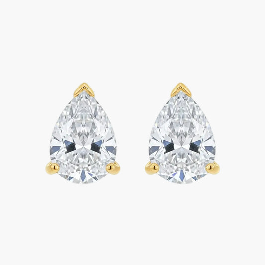 Pair of pear-shaped diamond stud earrings with gold settings on a white background