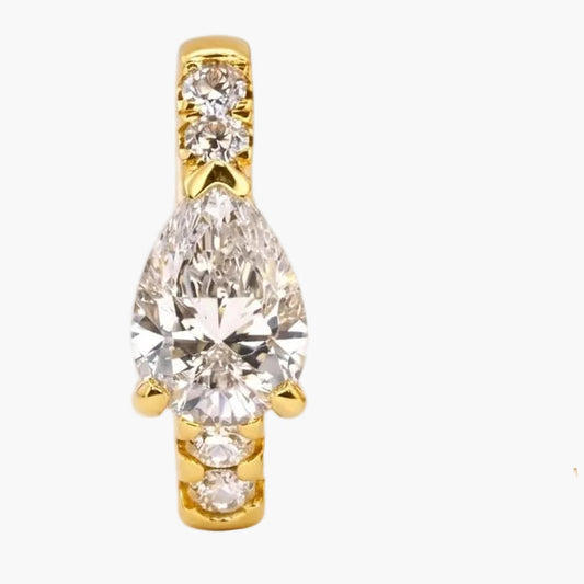 Gold hoop earring and teardrop-shaped stud earring on a white background