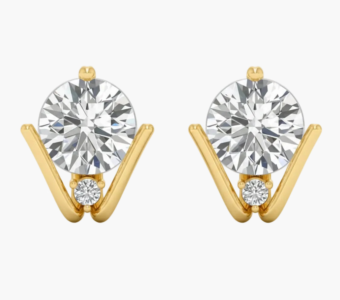 Gold earrings with large round gemstones on a white background