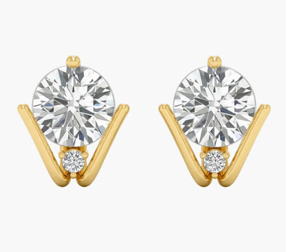 Gold earrings with large round gemstones on a white background