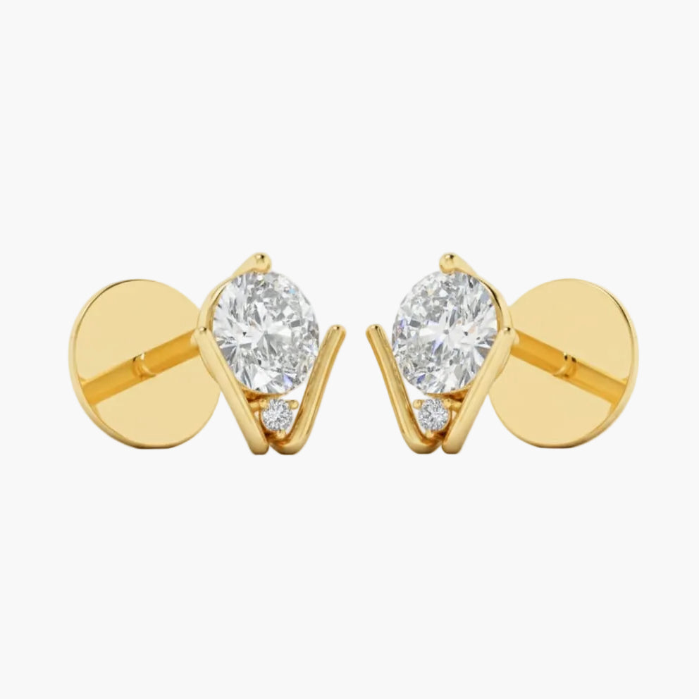 Gold earrings with clear gemstones on a white background