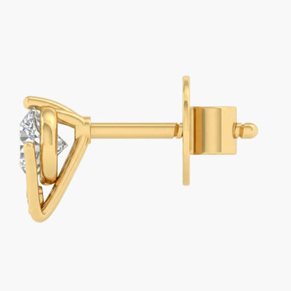 Gold earring with a clear gemstone on a light gray background