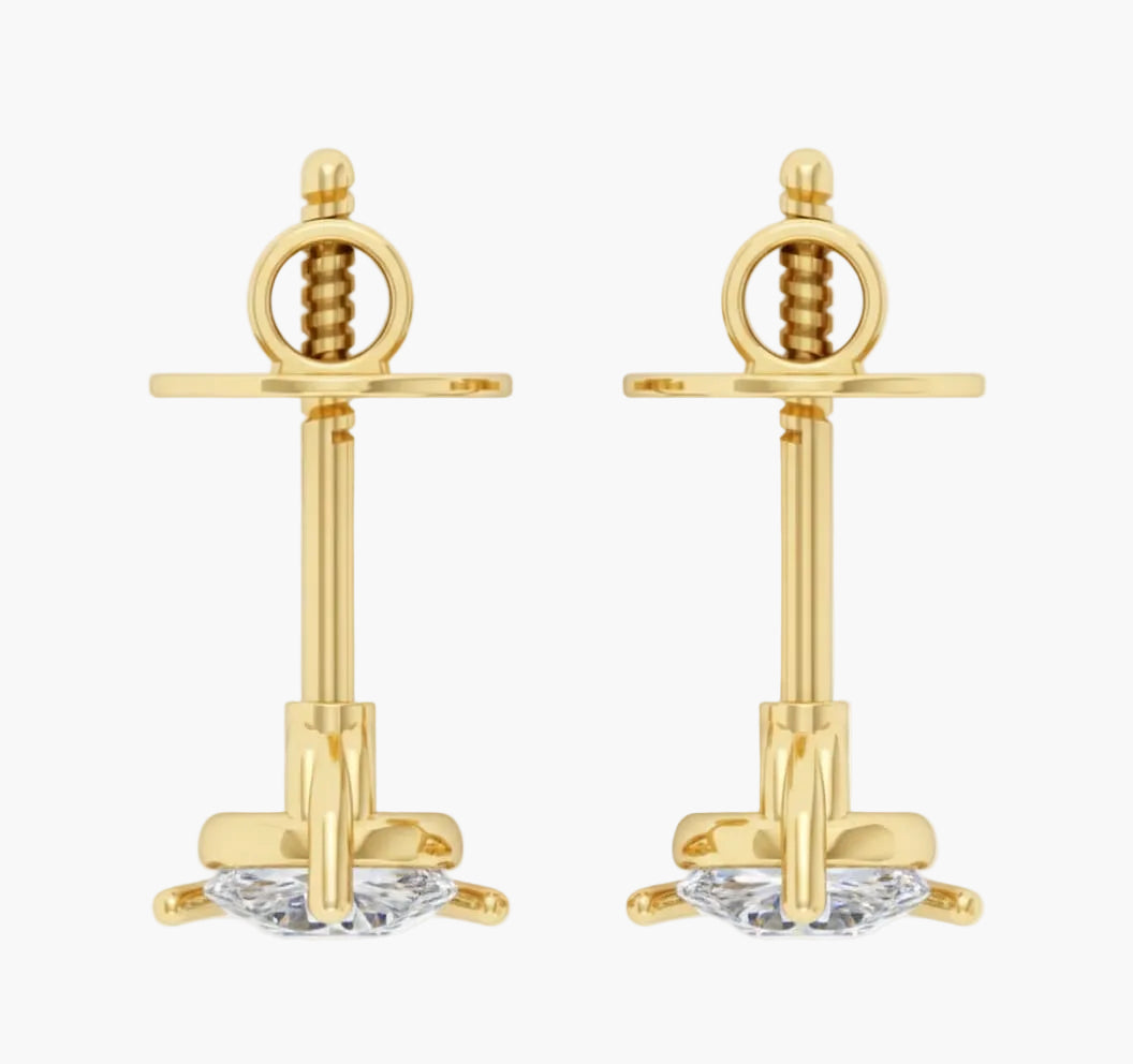 Gold earrings with intricate designs on a white background