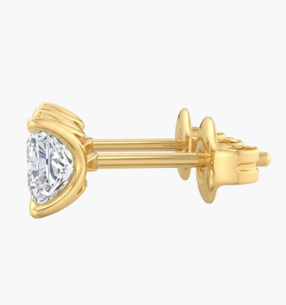 Gold earring with a heart-shaped diamond on a white background