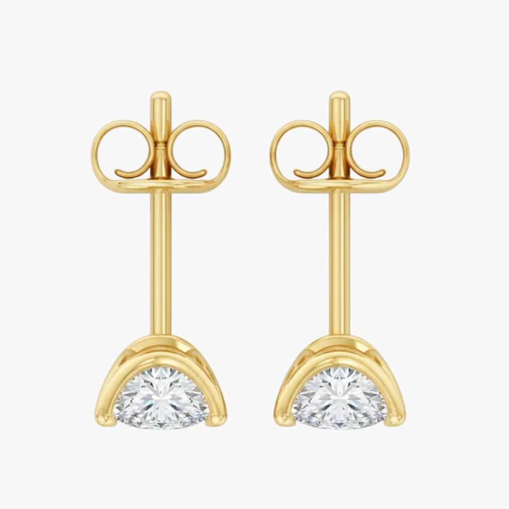 Gold earrings with clear gemstones on a white background