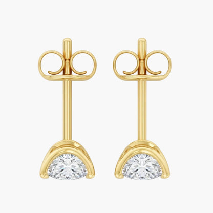 Gold earrings with clear gemstones on a white background