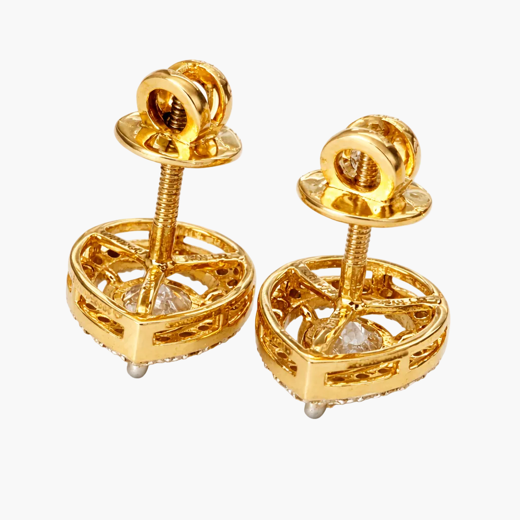 Pair of gold earrings with intricate designs on a white background