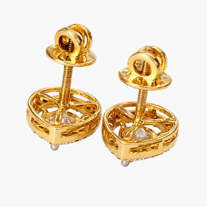 Pair of gold earrings with intricate designs on a white background