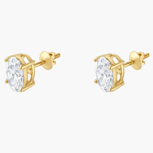Gold stud earrings with clear gemstones on a white background