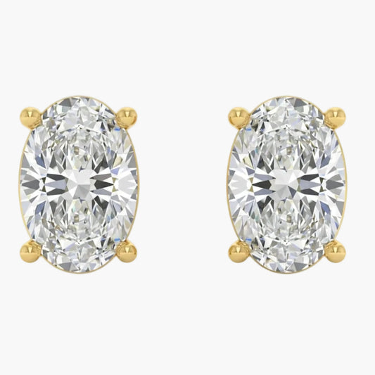 Gold earrings with large clear gemstones on a white background