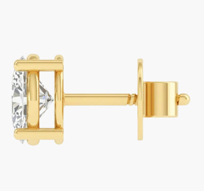 Gold earring with a clear gemstone on a white background