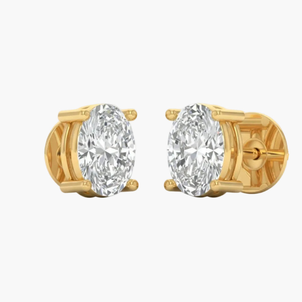 Gold earrings with large clear gemstones on a white background