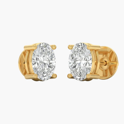 Gold earrings with large clear gemstones on a white background