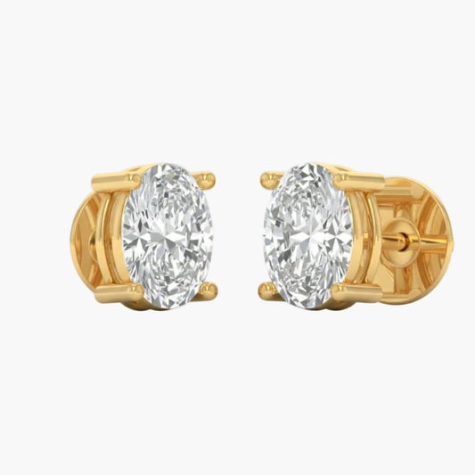 Gold earrings with large clear gemstones on a white background