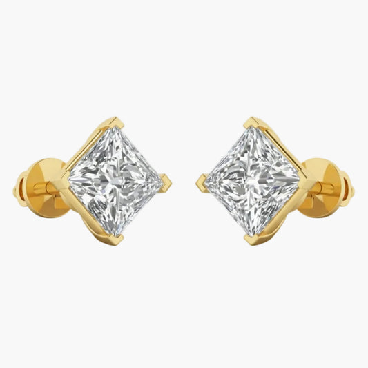 Gold earrings with clear gemstones on a white background