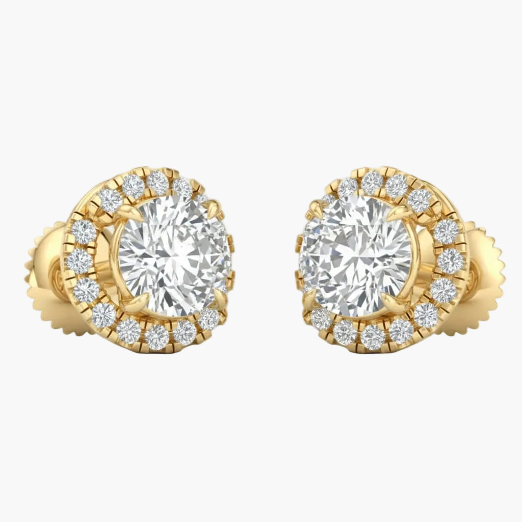 Gold earrings with large central gemstones and smaller stones around on a white background