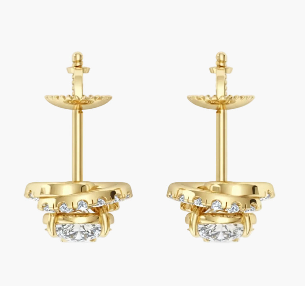 Gold earrings with clear gemstones on a white background
