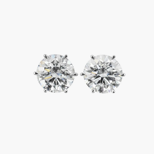 Pair of diamond stud earrings on a white background