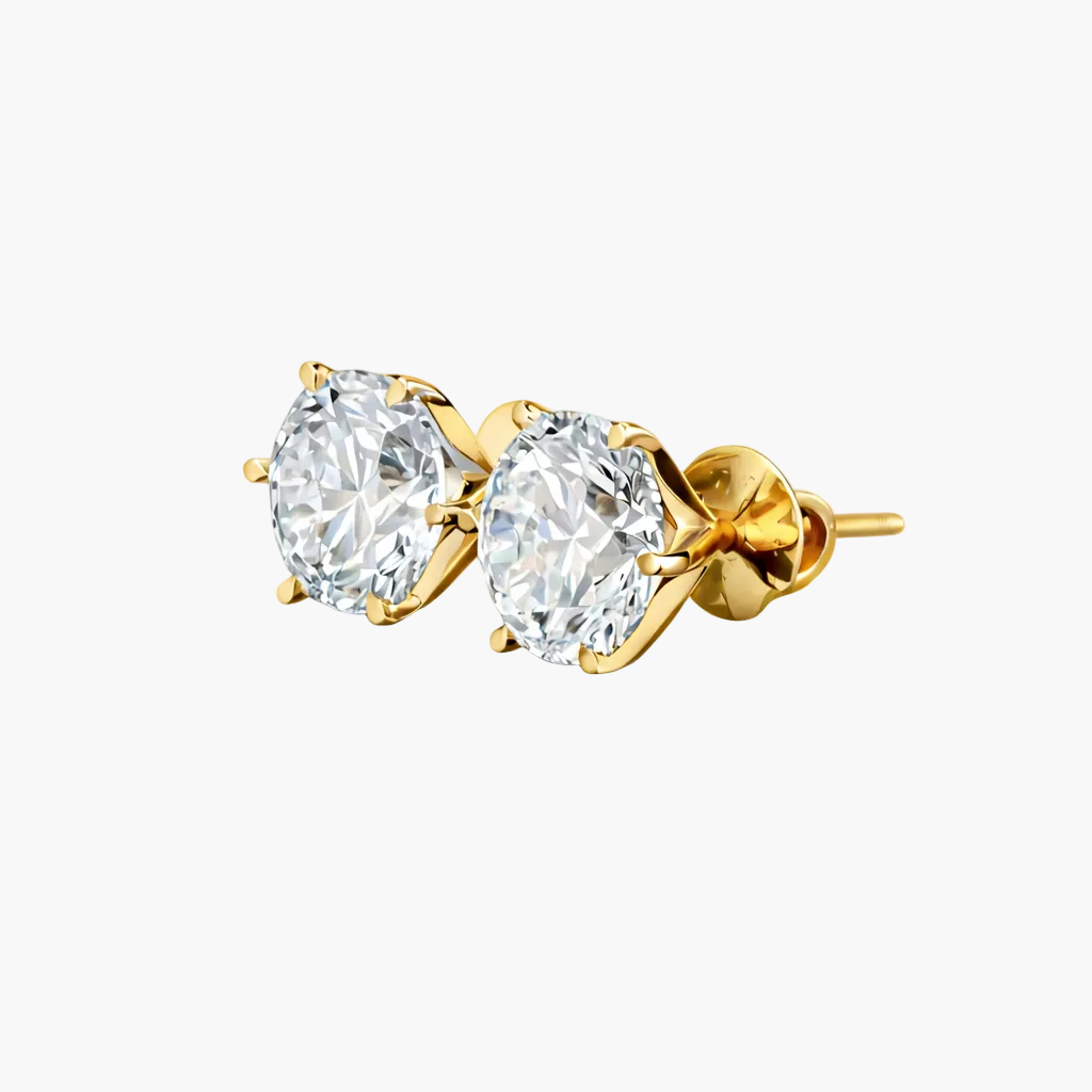 Gold earrings with clear gemstones on a white background