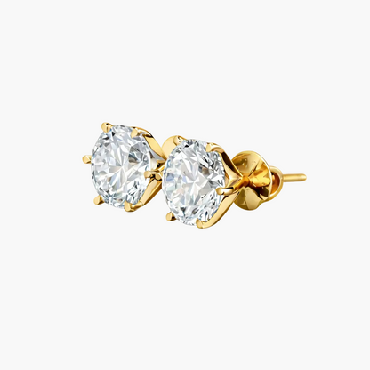 Gold earrings with clear gemstones on a white background