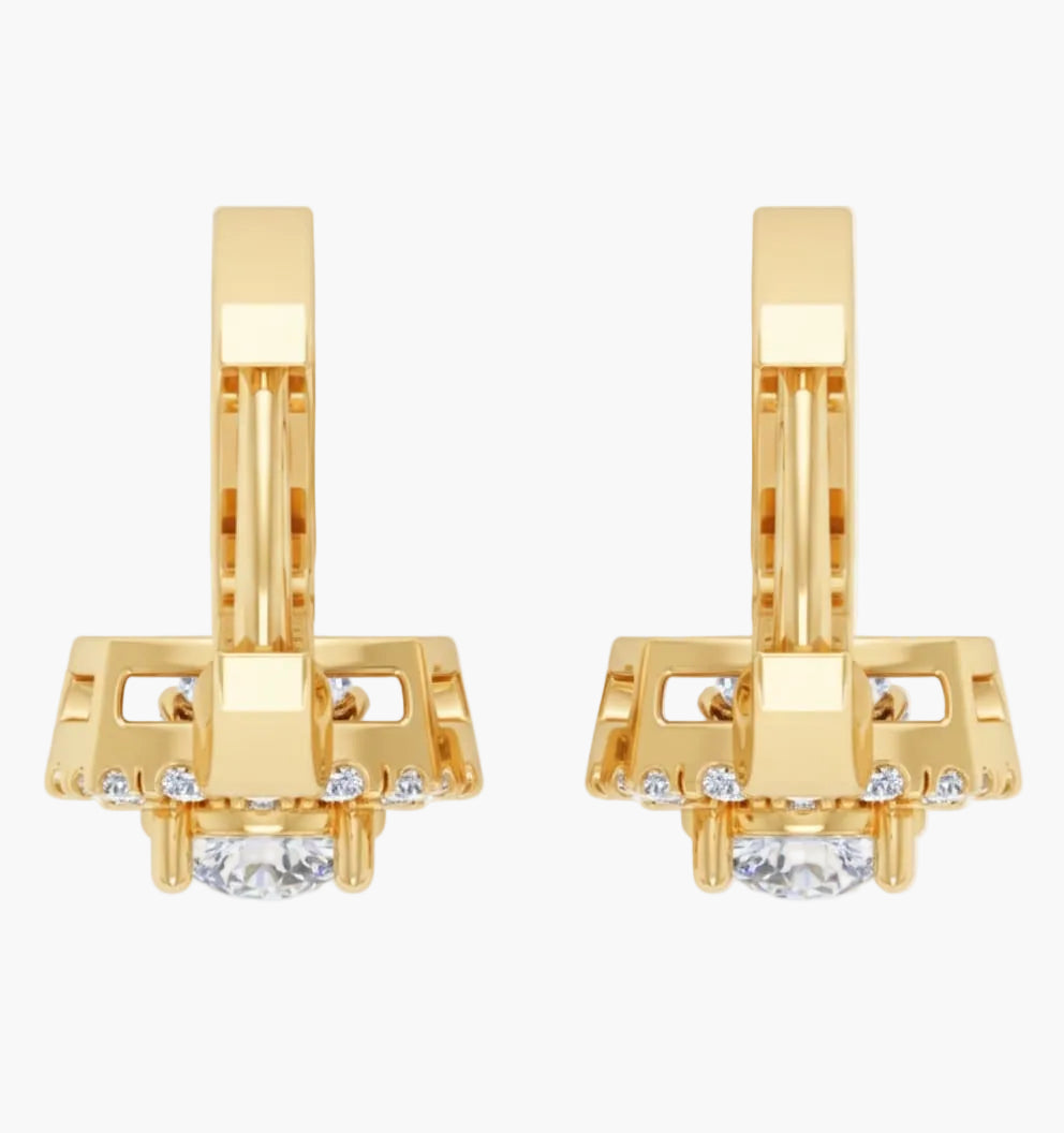 Gold earrings with clear gemstones on a white background