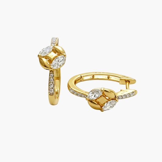 Gold hoop earrings with clear gemstones on a white background