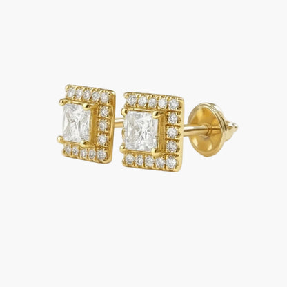 Gold square earrings with clear gemstones on a light gray background
