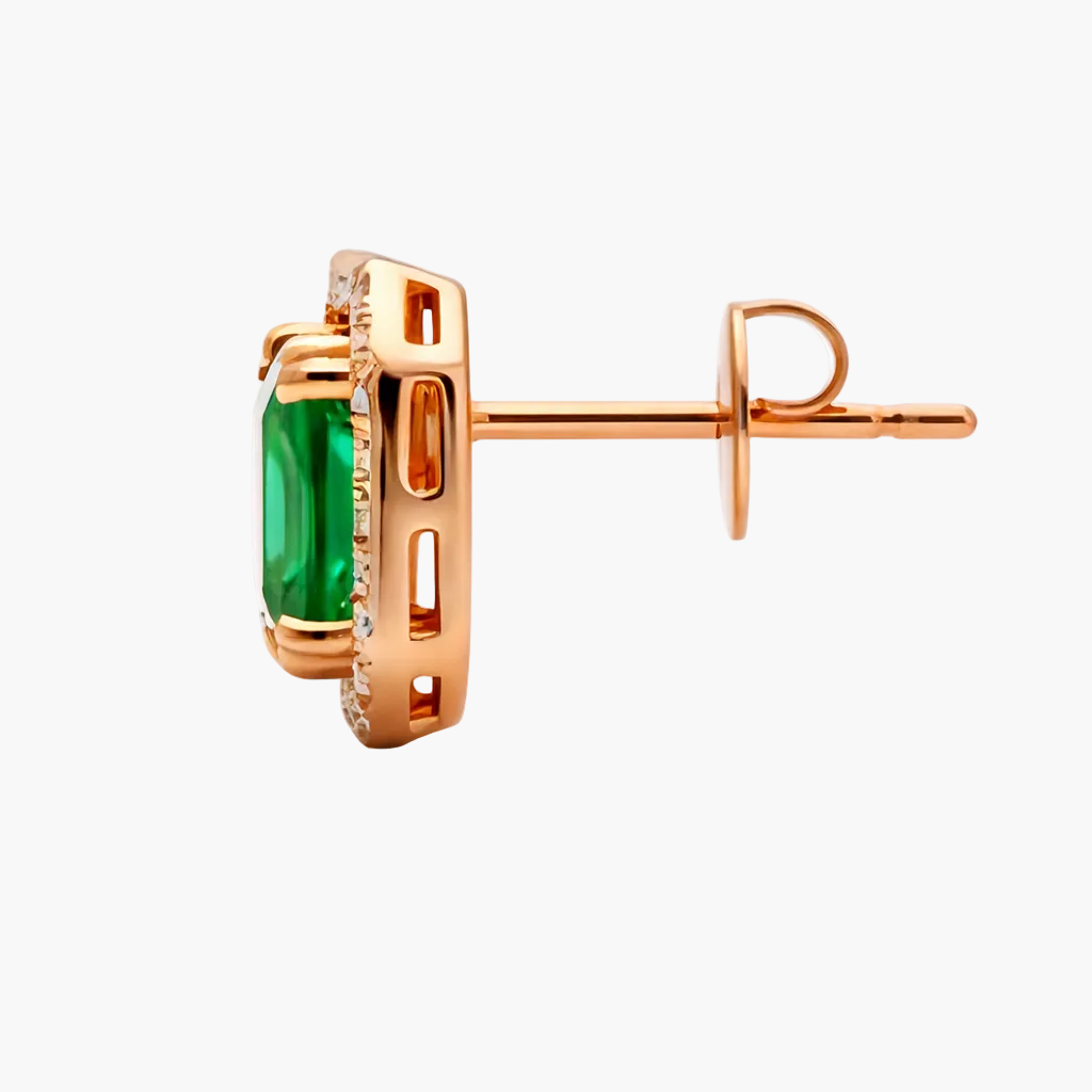 Rose gold earring with a green gemstone on a white background