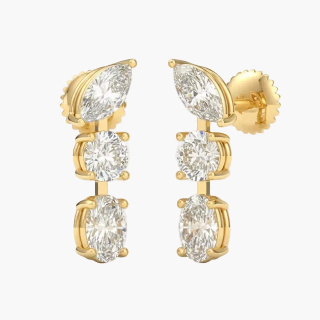 Gold earrings with clear gemstones on a white background