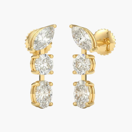 Gold earrings with clear gemstones on a white background