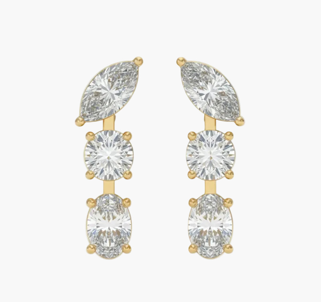 Gold earrings with clear gemstones on a white background