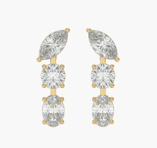 Gold earrings with clear gemstones on a white background