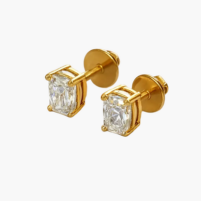 Gold earrings with clear gemstones on a white background