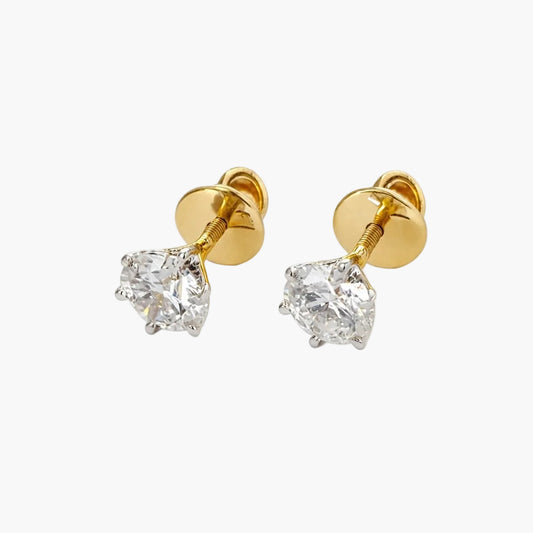 Gold earrings with clear gemstones on a white background